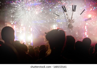 Clock close to midnight, fireworks and crowd waiting for New year - Shutterstock ID 168153161