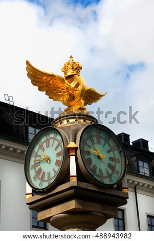 Clock with coat of arms next to  the central train station of Stockholm, Sweden.