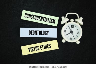 Clock and colored paper with the words consequentialism, deontology, and virtue ethics. The three most influential schools of thought.