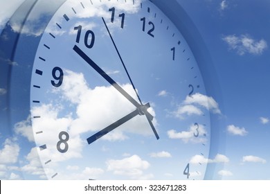 Clock face in blue sky - Shutterstock ID 323671283