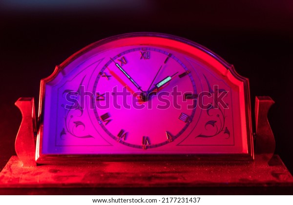 Clock face, close up. Arrows with\
phosphorescent, fluorescent paint that contains radioactive\
elements. Dangerous things at home. Old German clock.\
Dosimeter