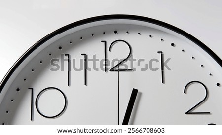 Clock face emerging from shadows, marking time and the rhythm of life