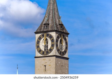Clock face of St. Peter church at Swiss City of Zürich showing exact twelve o'clock time on a sunny summer noon. Photo taken August 19th, 2024, Zurich, Switzerland.