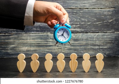 The Clock In The Hands Of A Businessman And Team. Overtime Increase Work Efficiency. Reducing The Cost Of Work. Reduction And Increase In Working Hours Per Week. Time Management. Selective Focus