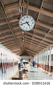 Clock hanging over head at train stations.Train platform with clock hanging on roof