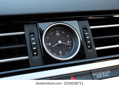 Clock Inside the Centre Console Interior. Car interior details of chronometer analog clock, dashboard. Luxury car clock close up. 