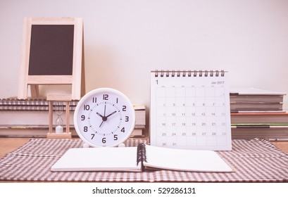 Clock And January 2017 Calendar On Table