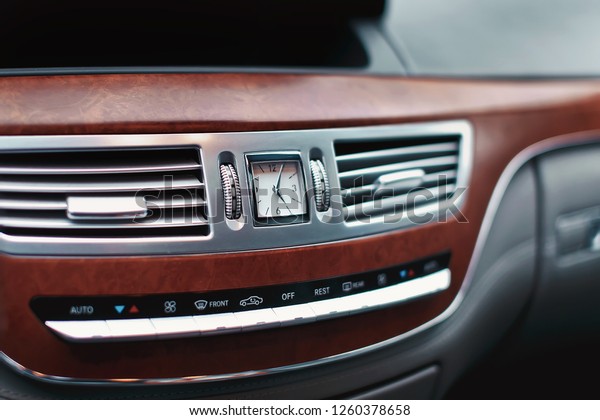 Clock in luxury car dashboard. Watch\
in transportation. Air conditioner ventilation in\
car.