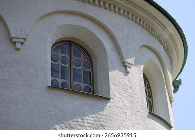 A clock is mounted on the side of a white building, providing a clean and modern design element.