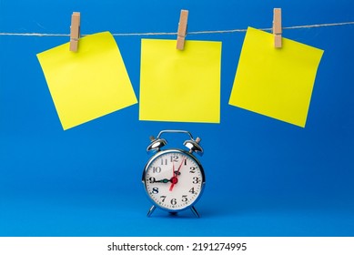 A Clock Next To A Rope With Yellow Sticky Notes Hanging Down To Include Goals, Reminders, Important Dates Or Birthdays. Blue Background. Time To Remember Moments