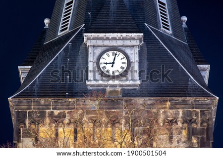 The clock of the oldest church in the city of Enschede in the Netherlands point 21.00 hours. The time of the curfew in the Netherlands during covid-19.