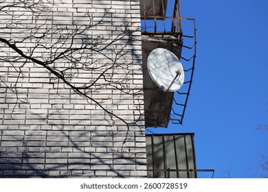 A clock on the side of a brick building, ideal for cityscapes and urban backgrounds.