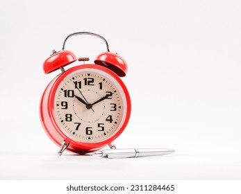 A clock and pen. Isolated with white background. - Shutterstock ID 2311284465