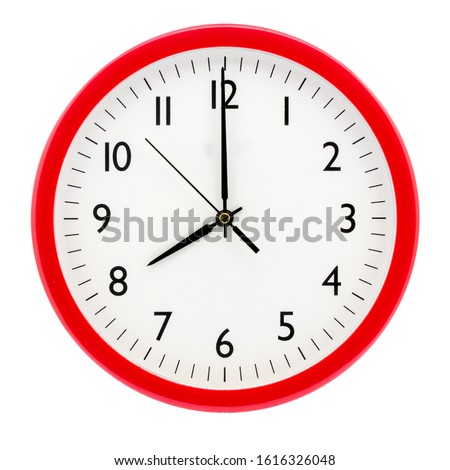 Clock with red round frame on white isolated background shows 8(20) hours 00 minutes