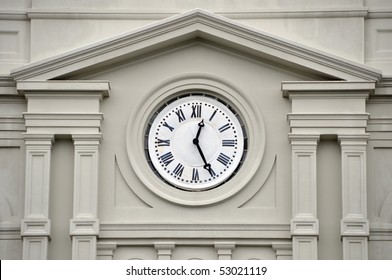 Clock With Roman Numerals On Exterior Of Building