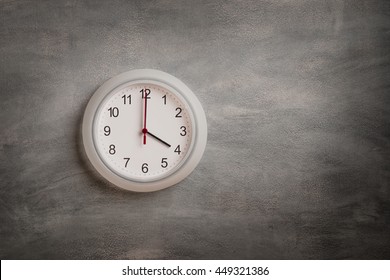 Clock Showing Four O Clock On Gray Wall