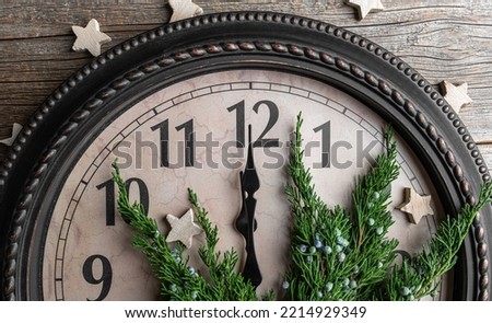 The clock shows midnight. New Year's decorations.