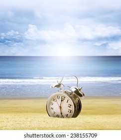 Clock Stuck In Sand At Beach, Bright Sky Behind