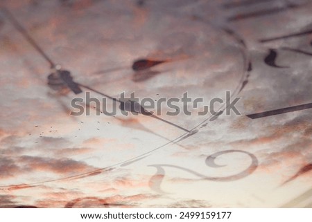 Clock and sunset sky, double exposure. Time concept