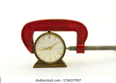 A Clock In The Tight Grip Of A Red Clamp Image With Copy Space In Horizontal Format