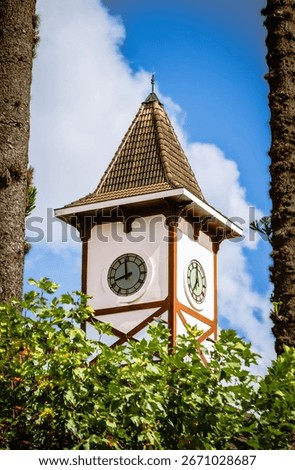 Clock tower between trees, Campos do Jordão, SP, Brazil - 30th April 2023