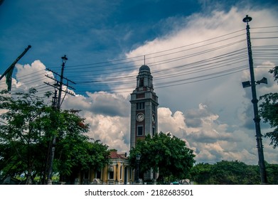 Clock tower with clouds in the background.