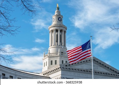 Clock Tower Of Denver City Hall - A Close-up View Of The Clock Tower, Topped With A Golden Eagle, Of Denver City And County Building, With A US Flag Flying At Front. Denver, Colorado, USA.