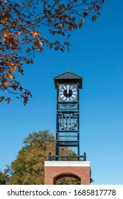clock tower with fall leaves trees in foreground
