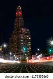 Clock tower at night with red hands
