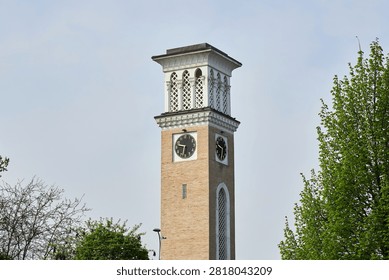 Clock tower with ornate gothic architecture rising against a clear sky. Historic landmark for urban landmark design. Classic stone structure with timepiece for time and history concept.