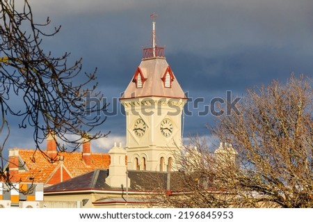 The clock tower of the Post Office lit by bright afternoon autumn sunshine - Kyneton, Victoria, Australia