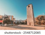 The Clock Tower (Sahat Kula) in Podgorica old town, Montenegro is a historical landmark, standing tall as a symbol of the city past, surrounded by autumn trees and narrow streets.