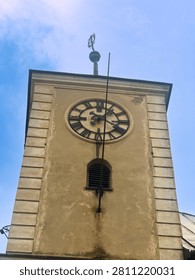 Clock tower shows time in clear daylight. A clock tower stands tall against the sky. The clock displays the hour with clear numbers.
