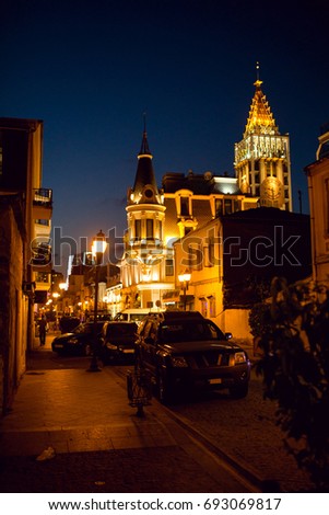 The clock tower is visible at the end of the streets of the old town of Batumi. Night photo with beautiful lighting. Adjara, Georgia
