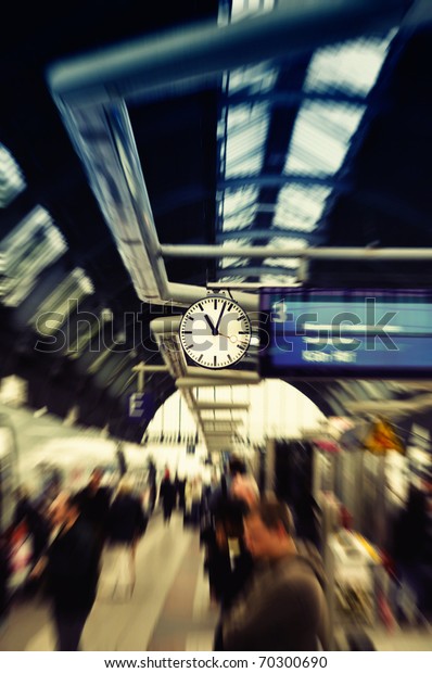 Clock watch in modern train station\
(Grand Central Station). Frankfurt am Main, Germany. Selected focus\
on clock. Peoples are blurred to show dynamic\
movements