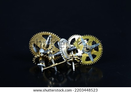 Clock wheels, metal gears on black background