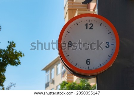 A clock without clock hands in the street. Timeless concept. Public clock mockup in the street. 