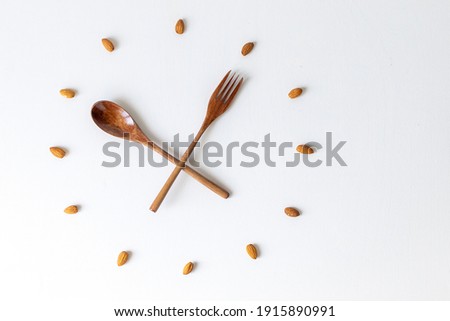 clock, wood spoon and fork clock, bamboo cutlery, almond nuts, almonds, clock on white background, lunch time breakfast time, meal time, healthy eating, eco-friendly, eco-friendly