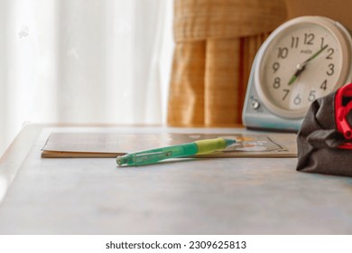 Clock and writing tools on study desk