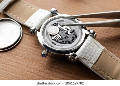 Clockmaker Repairing Watch At Table, Closeup