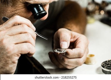 Clockmaker repairing wrist watch. Macro shot.