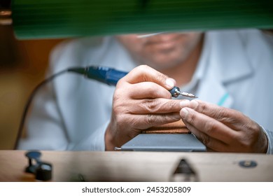 Clockmaker repairing wrist watch in a workshop. - Powered by Shutterstock