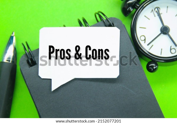 clocks, notebooks and conversation bubbles with\
the words pros and cons\
Concept