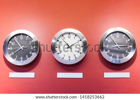Clocks on the wall showing different time zones.