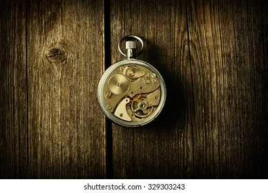 Clockwork Mechanism Over Wooden Background 