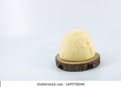 clod of Breton butter churned and molded the former with a salty taste on a wooden tray - Shutterstock ID 1699758244