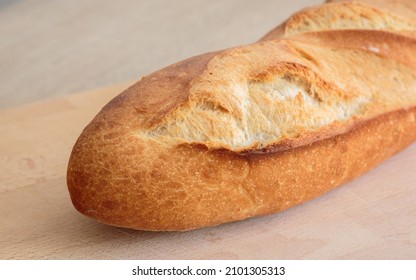 cloesup of a french baguette bread on a wooden board
