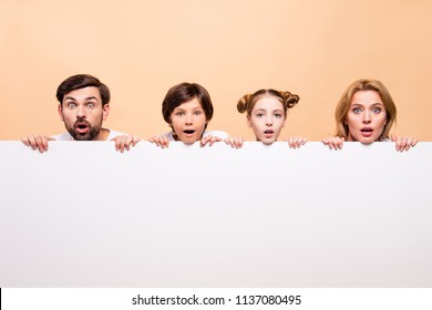 Cloesup portrait of adorable attractive beautiful family, bearded father, blonde mother, boy and girl holding white copy space in front