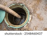 Clogged septic tank. Emptying the septic tank. Pipe in the drainage pit. Sewer cleaning service. High quality photo