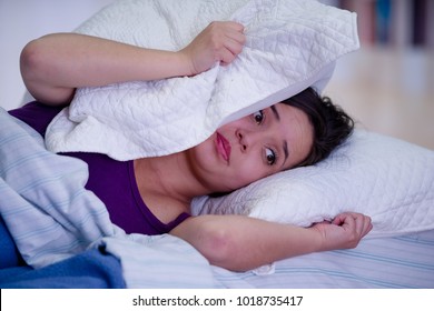 Cloise Up Of Young Beautiful Woman Suffering From Insomnia With A Pillow Over Her Head